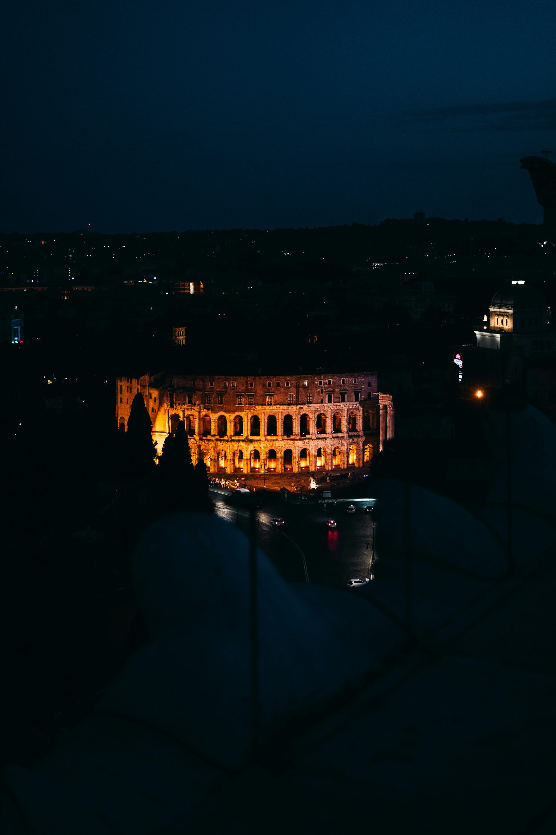 A view of a city at night from the top of a building